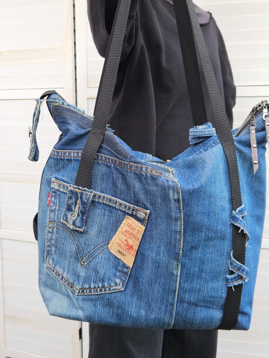 Handmade Denim Tote with Attitude Side view of large denim tote bag made from reclaimed jeans with shoulder straps and zip top