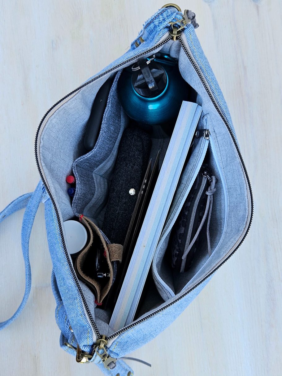 Light Denim Crossbody Bag With Pockets Inside of light denim crossbody bag showing organised compartments and practical storage