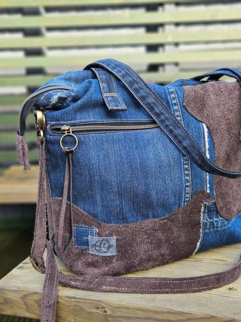 Stylish handbag made from denim and suede with a crossbody strap.