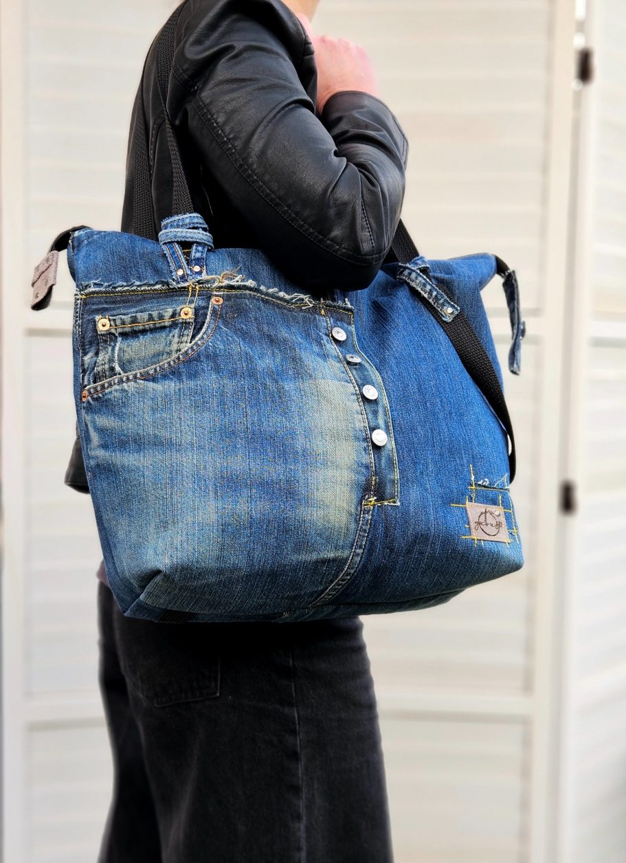 Blue Denim Tote Bag Blue denim tote bag with leather details, double zip closure and roomy everyday shape.