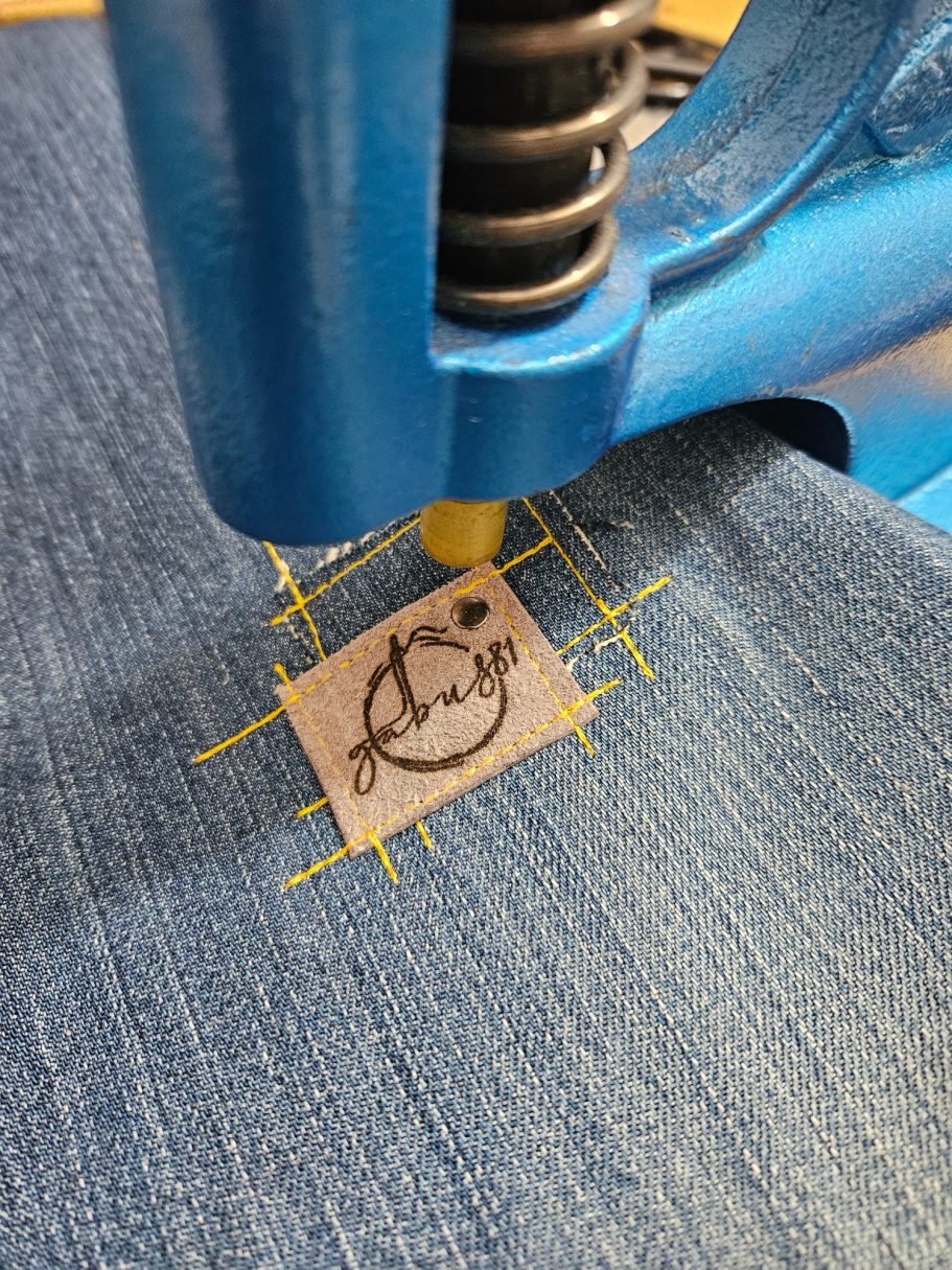 Handmade Denim Tote with Attitude Making process of Gabus81 label stitched onto reclaimed denim during bag creation