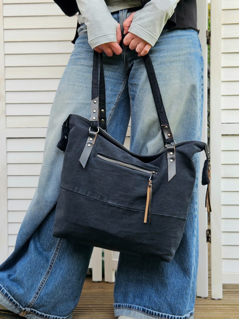 Large Black Denim Tote Large black denim tote bag worn with jeans, showing the size and everyday shoulder fit.