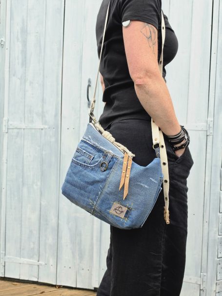 Denim Crossbody Bags Denim crossbody bag with adjustable strap worn at the hip