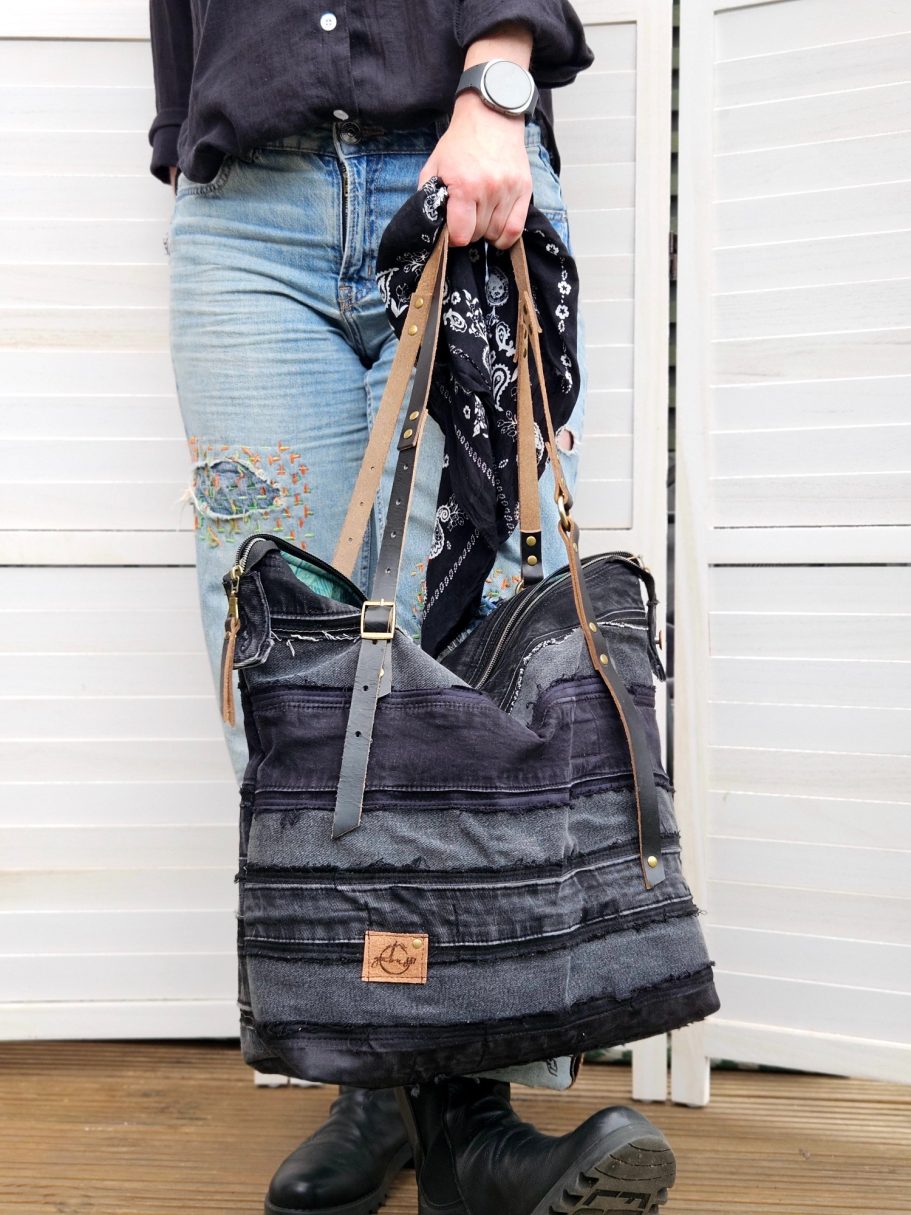 Black Denim Tote Black denim shoulder bag shown from the side, with double zip and relaxed handmade shape.