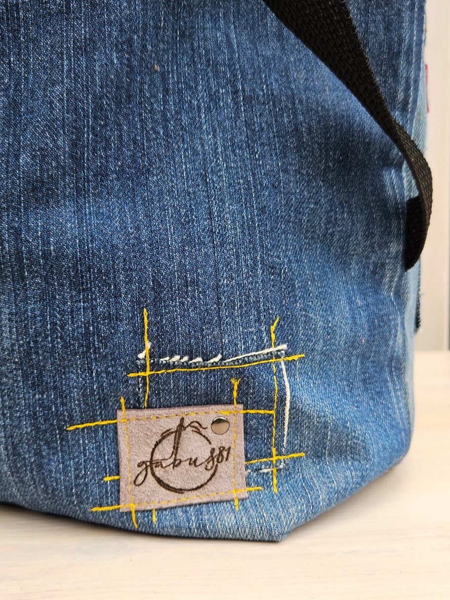 Handmade Denim Tote with Attitude Close up of handmade denim tote bag with stitched Gabus81 label on blue reclaimed denim