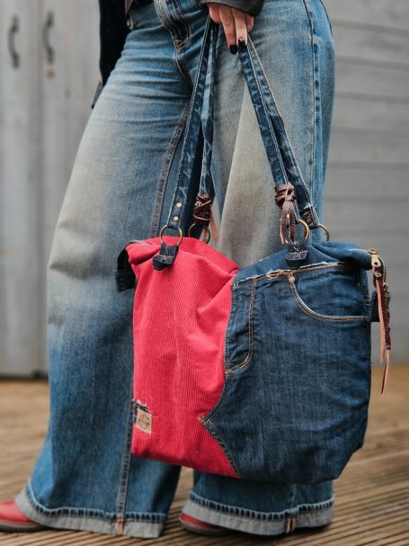 Denim Tote Bags Large denim tote bag with red side panel carried on the shoulder