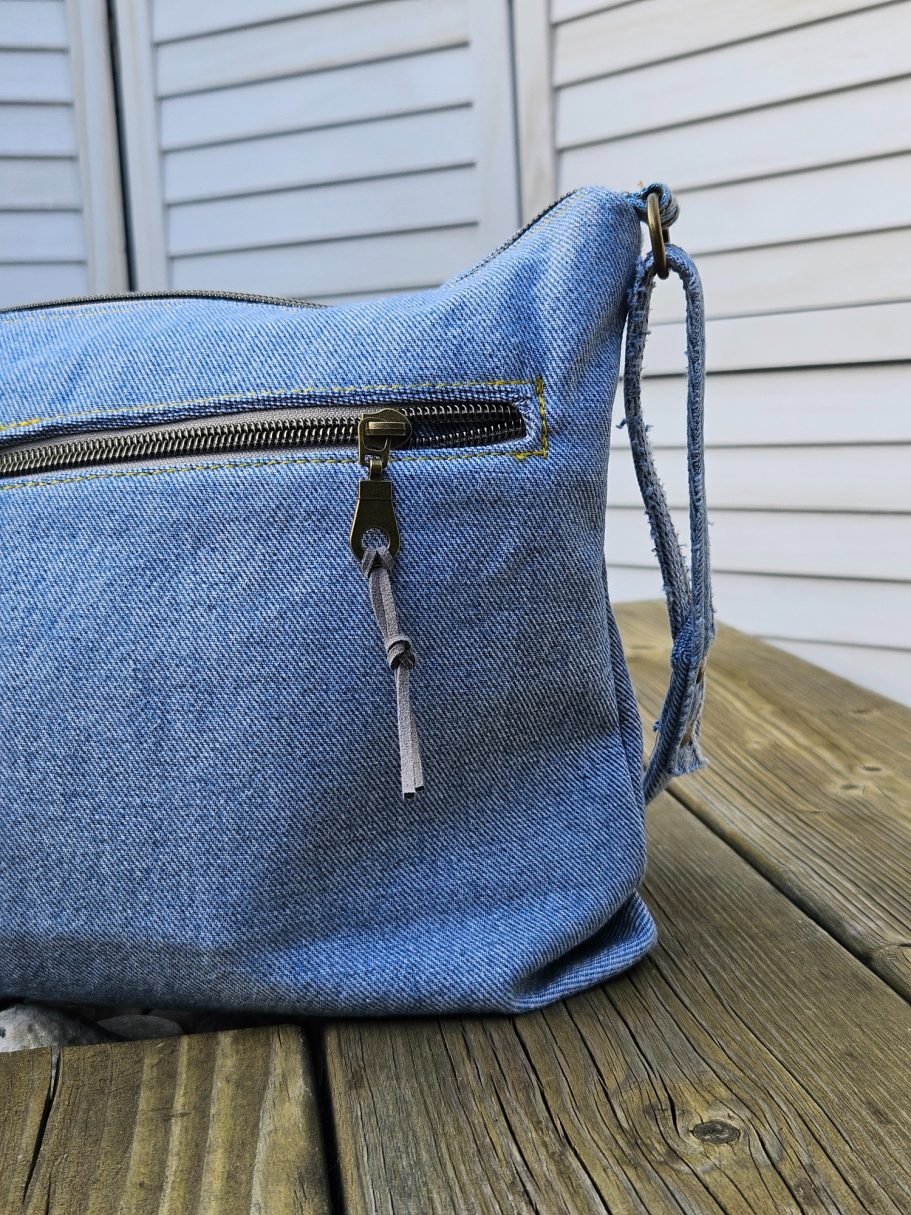 Light Denim Crossbody Bag With Pockets Light denim handbag made from upcycled jeans with double zip top and side profile