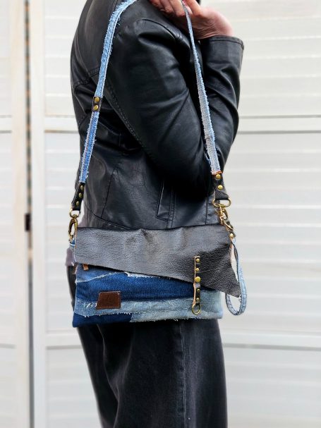 Denim Crossbody Clutch Denim crossbody clutch bag worn on shoulder with long strap and slim rectangular shape