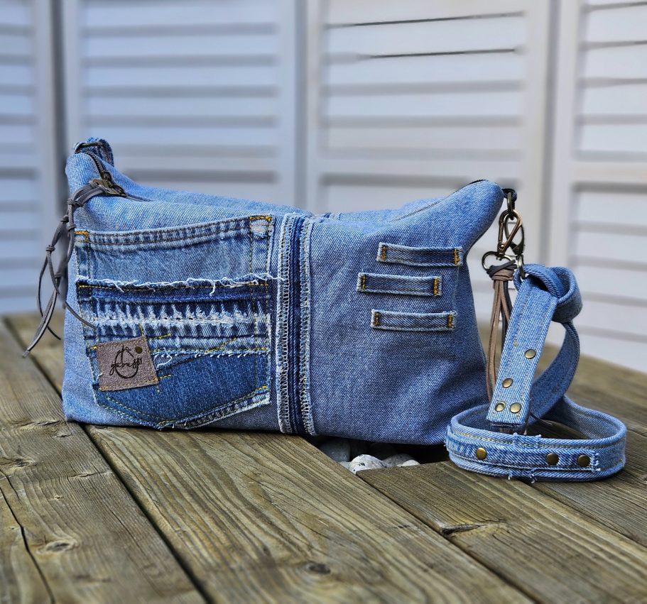Light Denim Crossbody Bag With Pockets Light denim crossbody bag made from reclaimed jeans with front pockets and adjustable strap