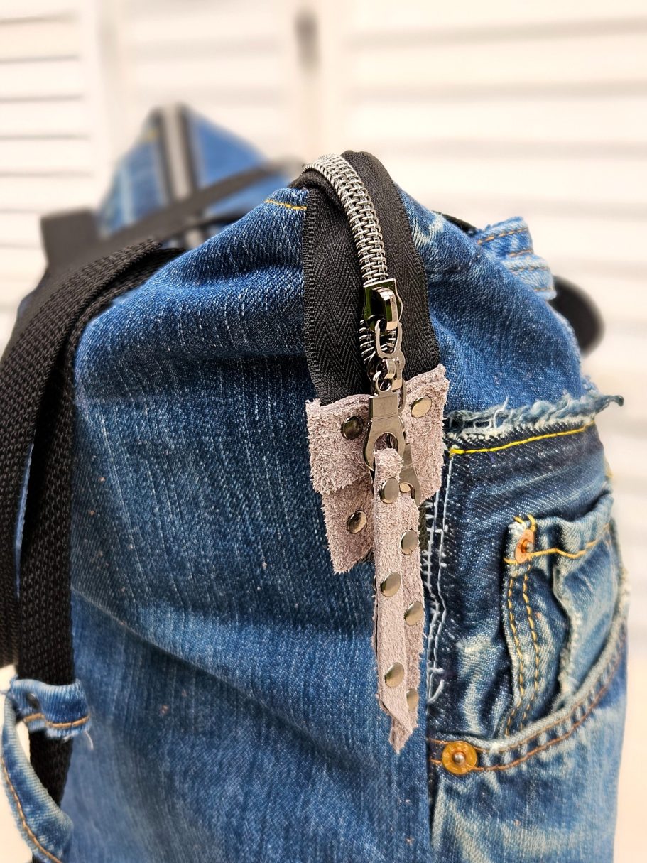 Handmade Denim Tote with Attitude Close up of denim tote bag front made from reclaimed jeans with original pocket and zippers details