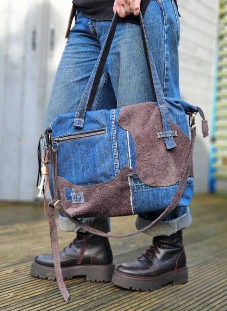 Denim and Leather Tote Denim and leather tote bag with front pocket, double zip top and soft structured body