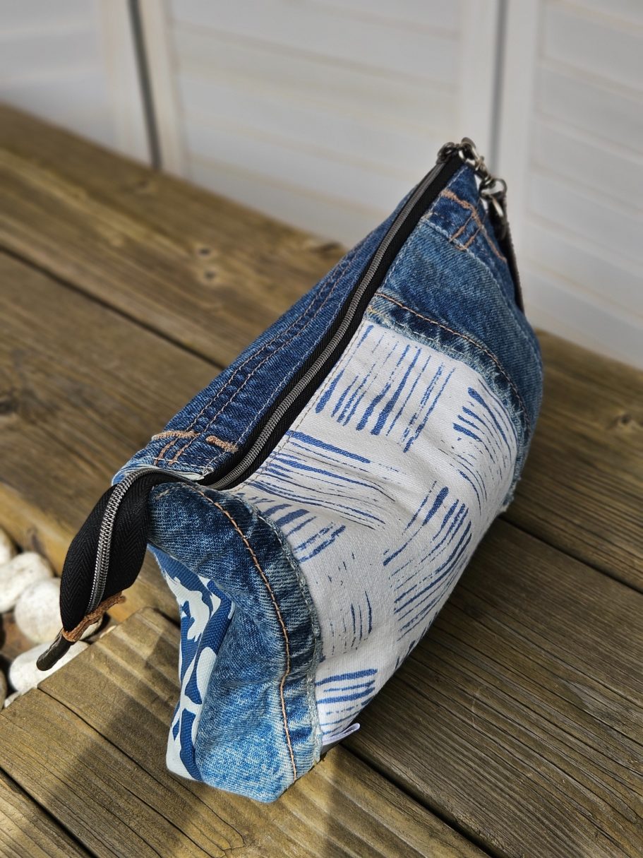 Pouch Shape Side view of a handmade denim pouch showing its shape, zipper and denim texture