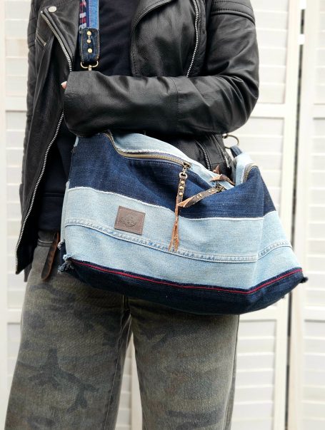 Denim Crossbody SOLD OUT Oversized denim crossbody bag worn across body with light and dark denim patchwork design