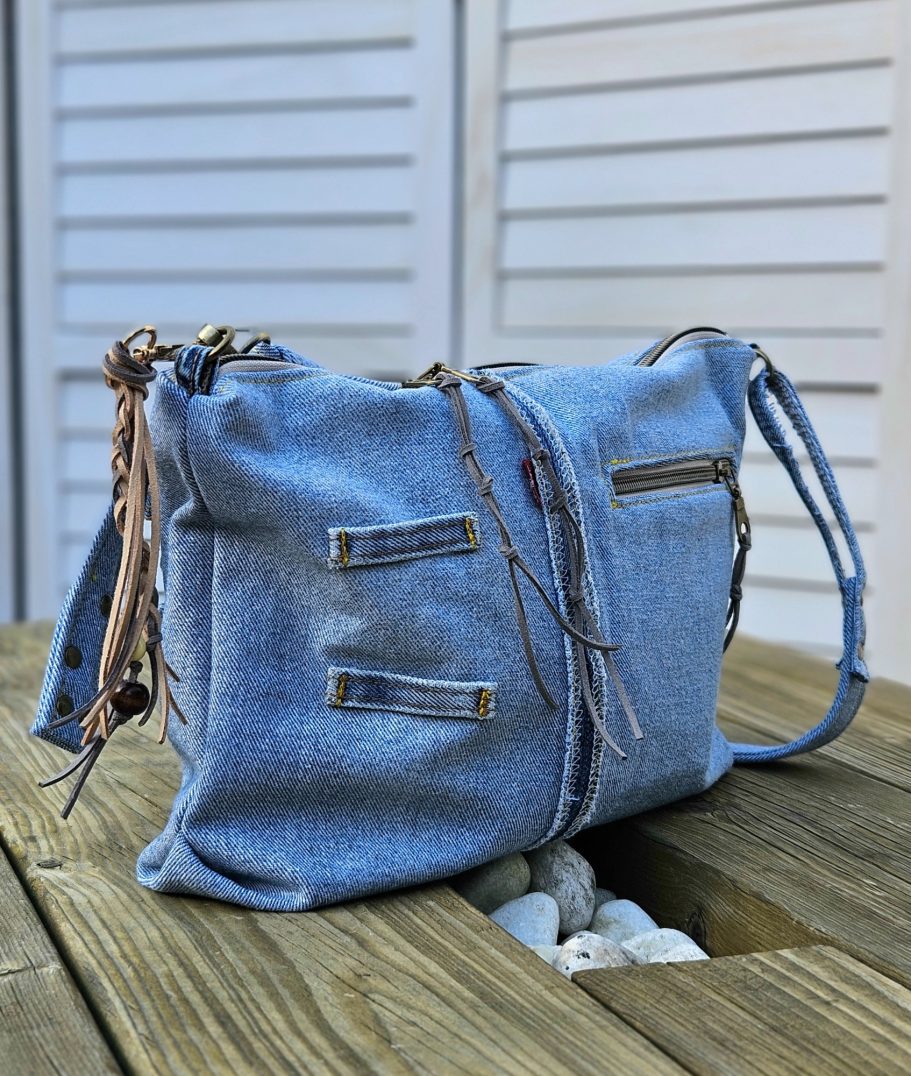 Light Denim Crossbody Bag With Pockets Back view of reclaimed denim crossbody bag with pocket details and soft summer look