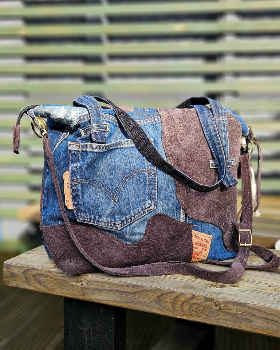 A patchwork shoulder bag made from denim and suede in various shades.